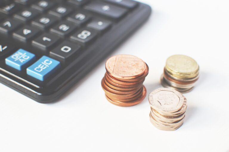 Coins next to a calculator symbolizing cost planning