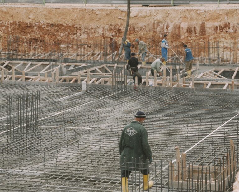 Workers building a concrete foundation with rebar